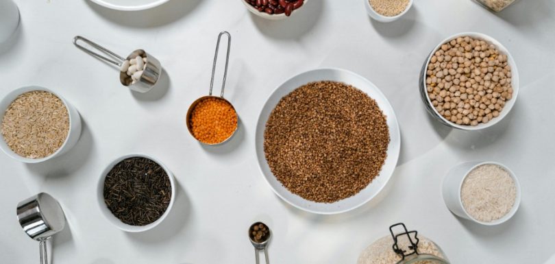 Bowls of beans, lentils, rice, oats, grains, and other healthy pantry staples